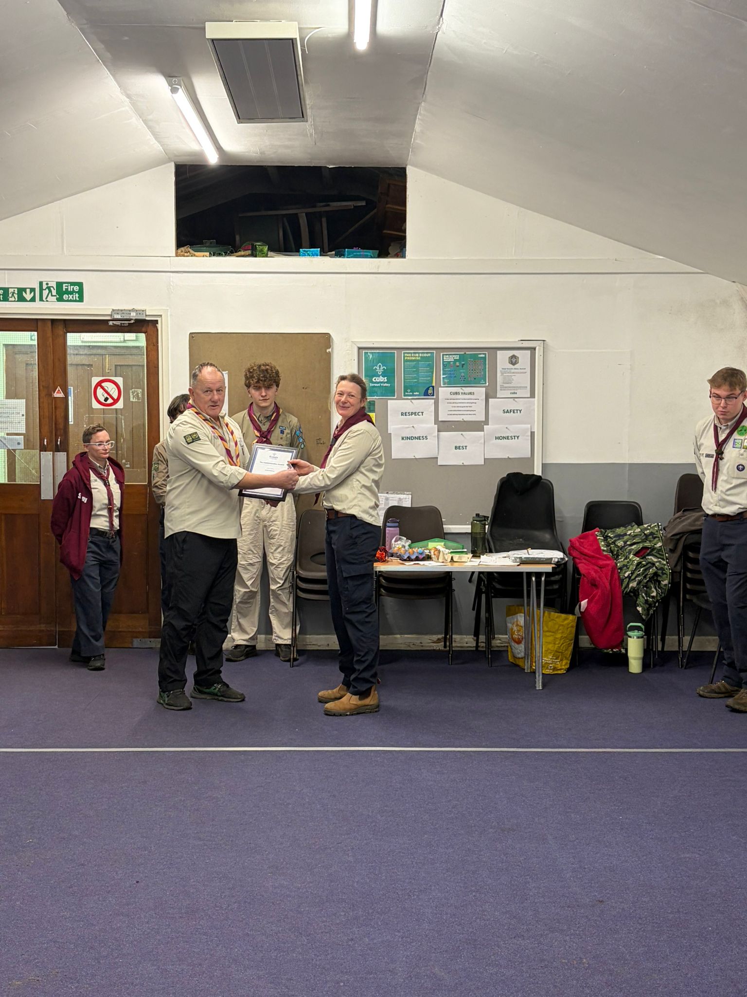 A Leader being invested and receiving a commendation award during a ceremony at Stroud Valley Scout Group