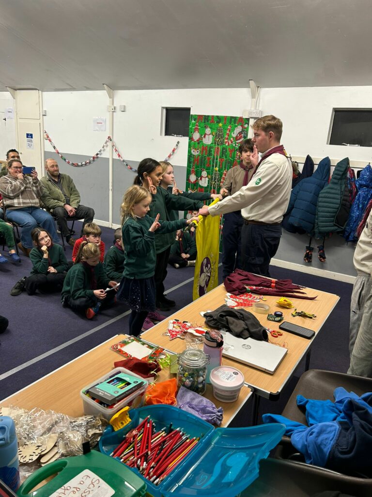 Cubs taking part in an investiture ceremony and making their Cub Scout Promise at Stroud Valley Scout Group
