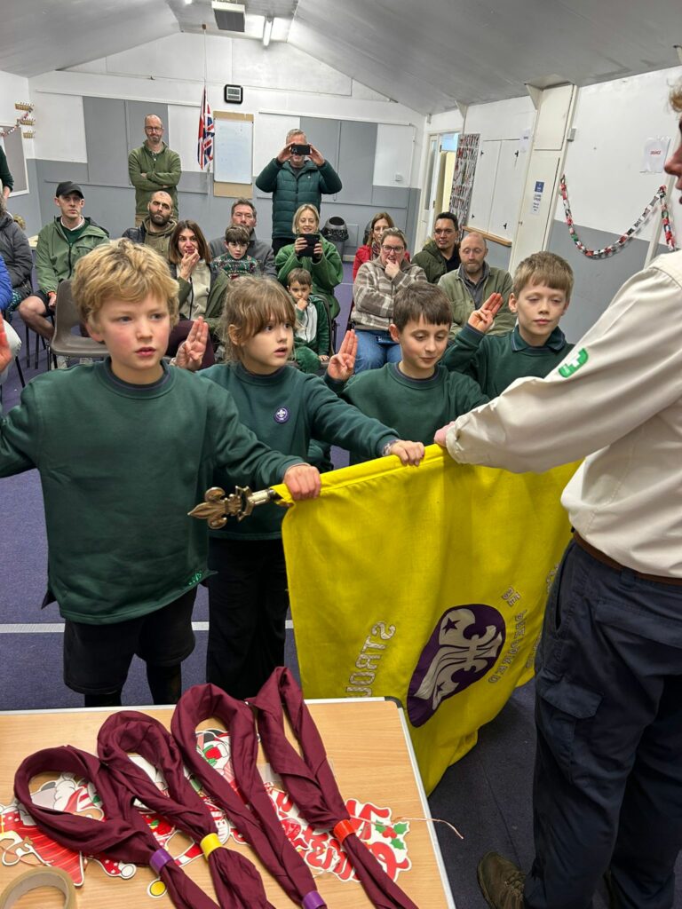 Cubs taking part in an investiture ceremony and making their Cub Scout Promise at Stroud Valley Scout Group