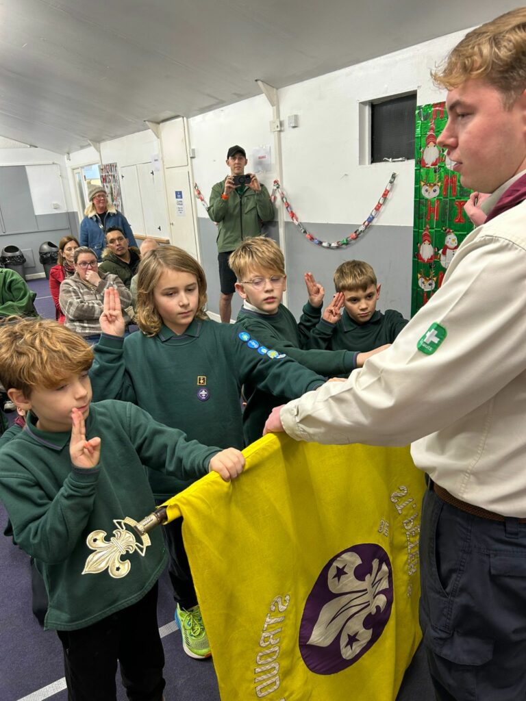 Cubs taking part in an investiture ceremony and making their Cub Scout Promise at Stroud Valley Scout Group