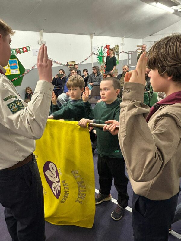 Cubs taking part in an investiture ceremony and making their Cub Scout Promise at Stroud Valley Scout Group