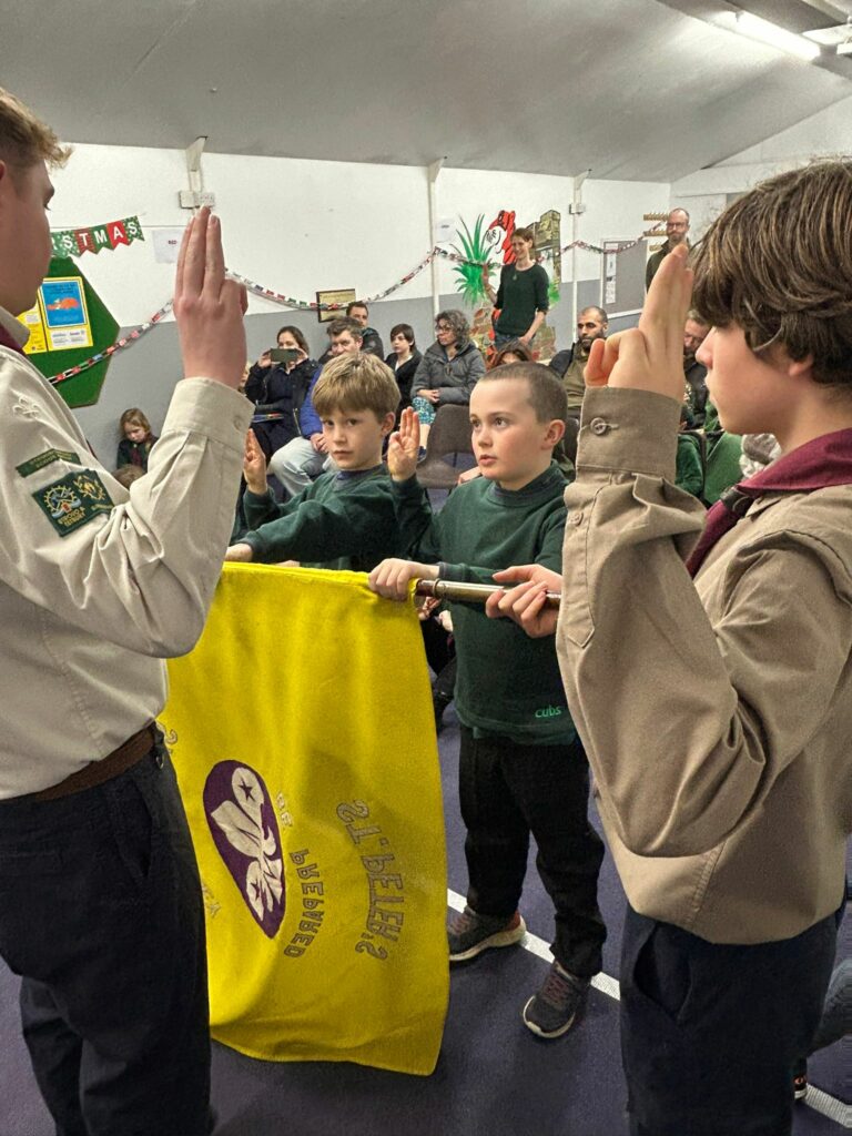Cubs taking part in an investiture ceremony and making their Cub Scout Promise at Stroud Valley Scout Group