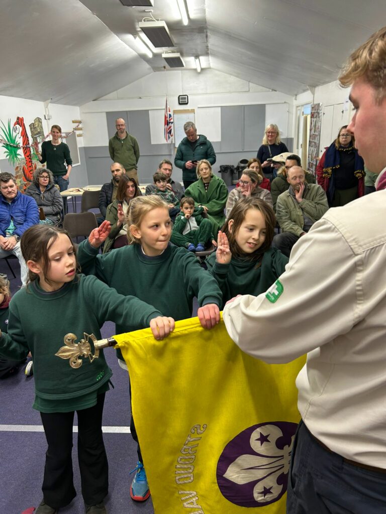 Cubs taking part in an investiture ceremony and making their Cub Scout Promise at Stroud Valley Scout Group