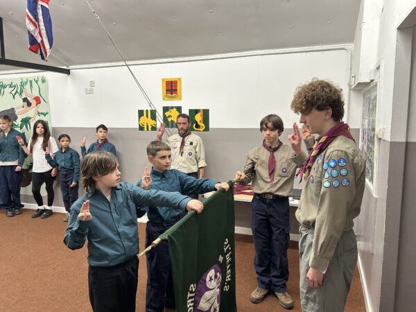 Scouts taking part in an investiture ceremony and making their Scout Promise at Stroud Valley Scout Group